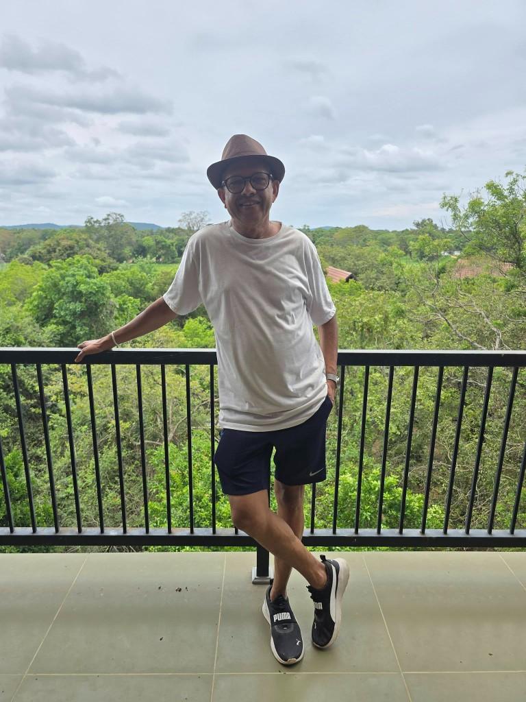Ariya Gallege on a balcony overlooking the forest